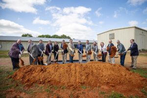 Team celebrating the groundbreaking of new feed mill.